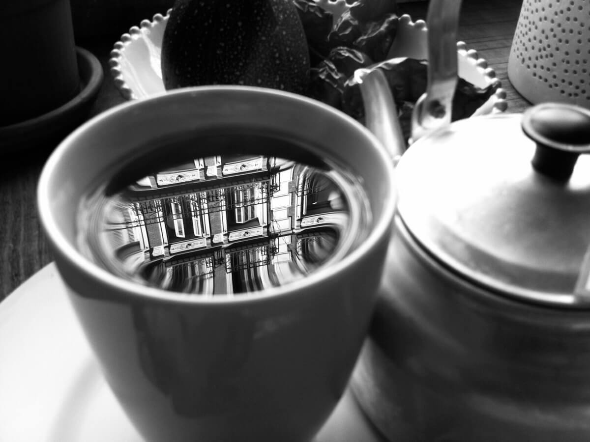a black and white image of a cup of tea