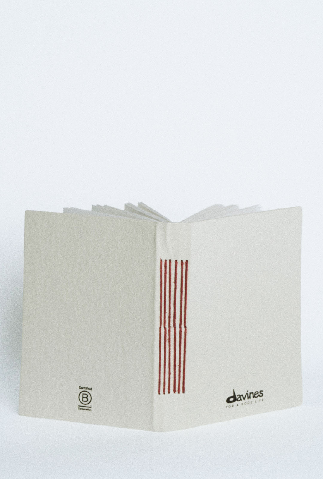 Davines For a Good Life Notebook - A place for ideas, inspiration, and the small moments in between. This notebook carries the For a Good Life spirit throughout.
The cover is care-crafted from banana fibers reinforced with natural wool, responsibly sourced from local communities in India. Inside, the pages are handmade from recycled paper. Thoughtful in both design and materials, it’s a simple reminder that even everyday objects can be made with greater intention.
