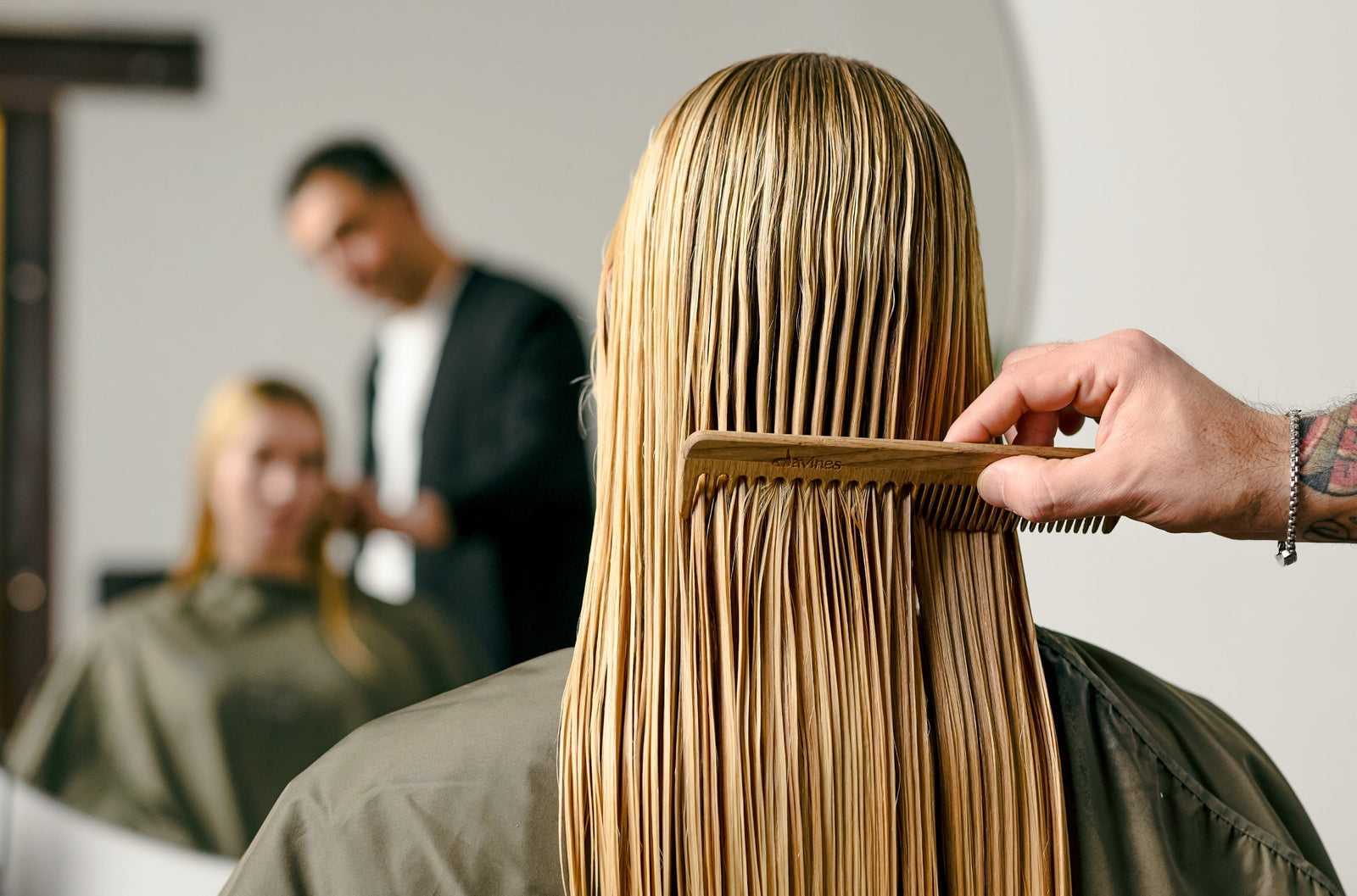 Davines stylist combing client's hair