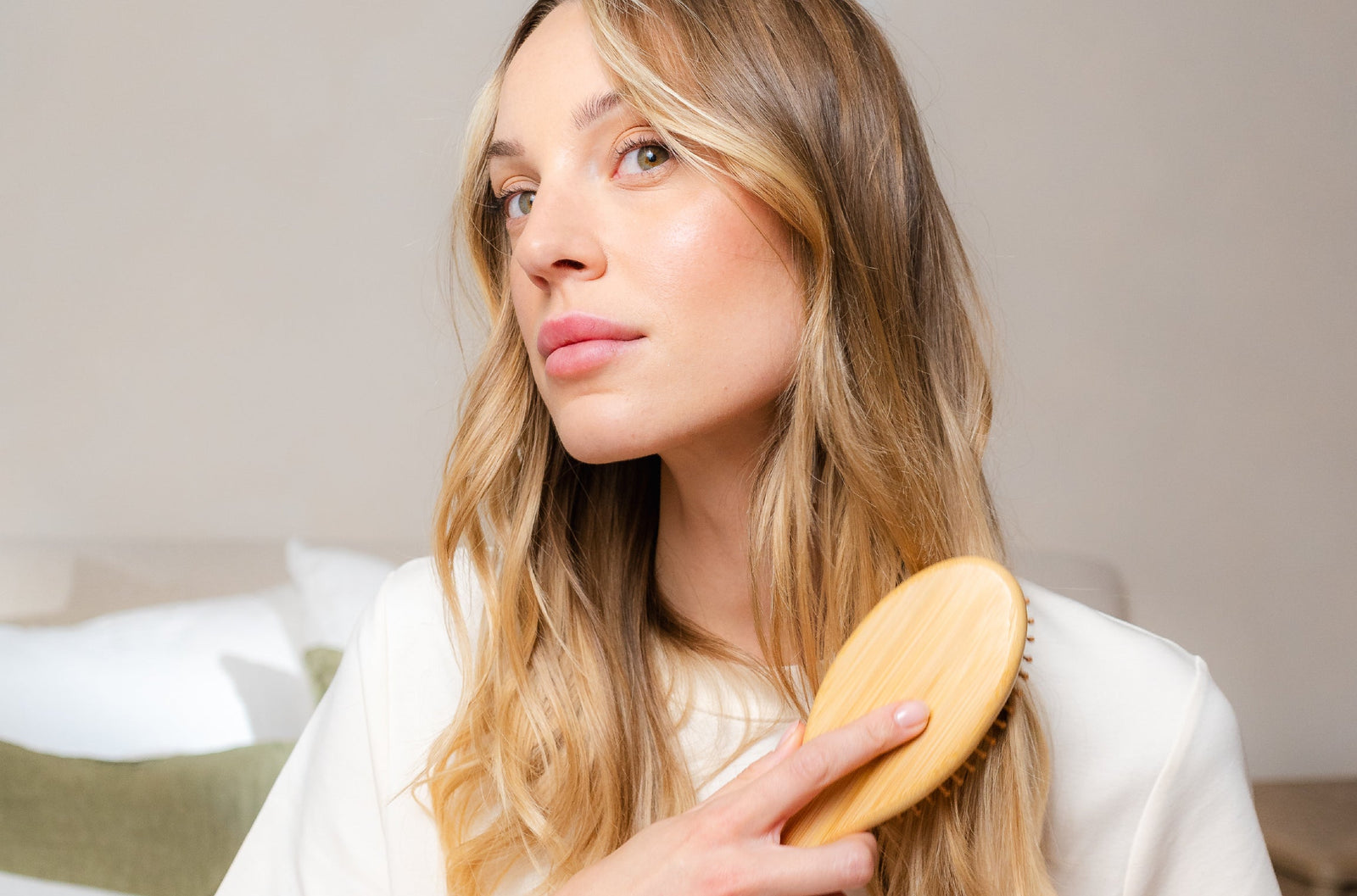 blonde woman brushing her hair