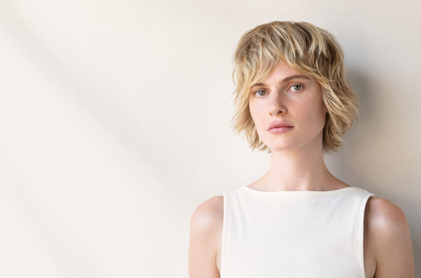 Woman with short, textured blonde hair