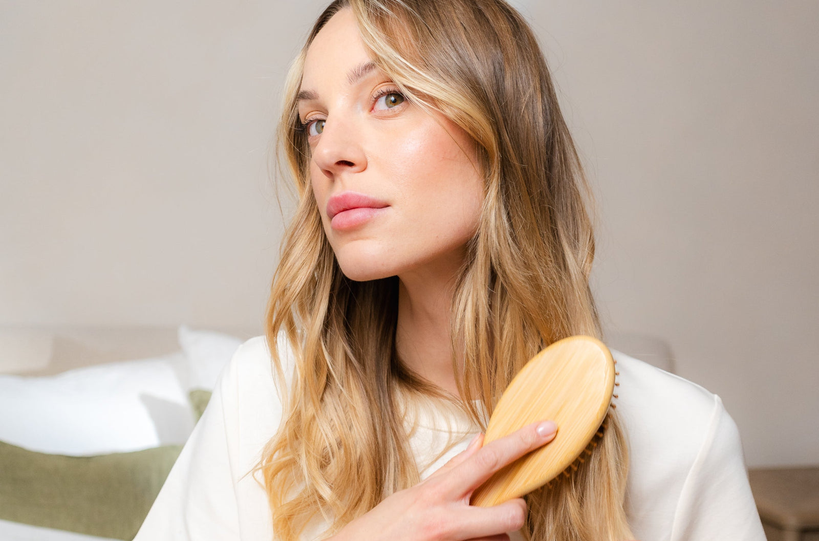 Blonde woman brushing her hair