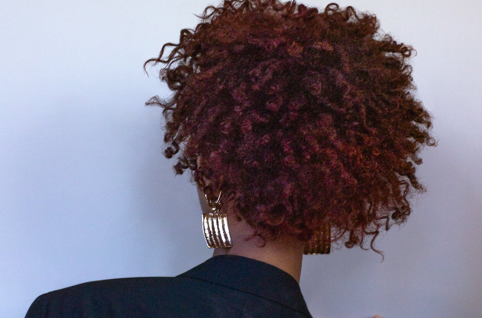 back view of a woman with auburn curls